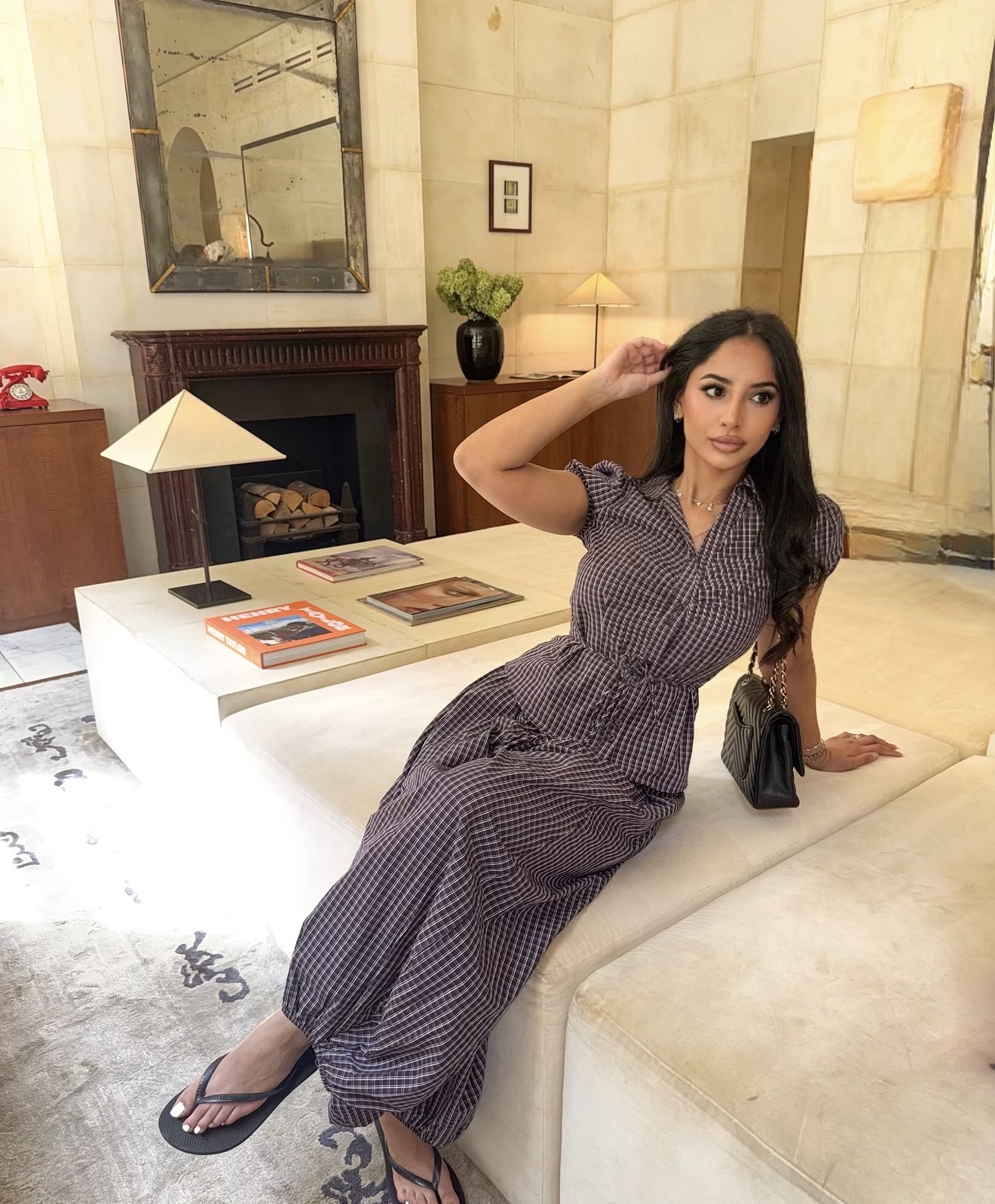 Laila, 20 year old escort in Melbourne, relaxed and smiling with a glass of wine